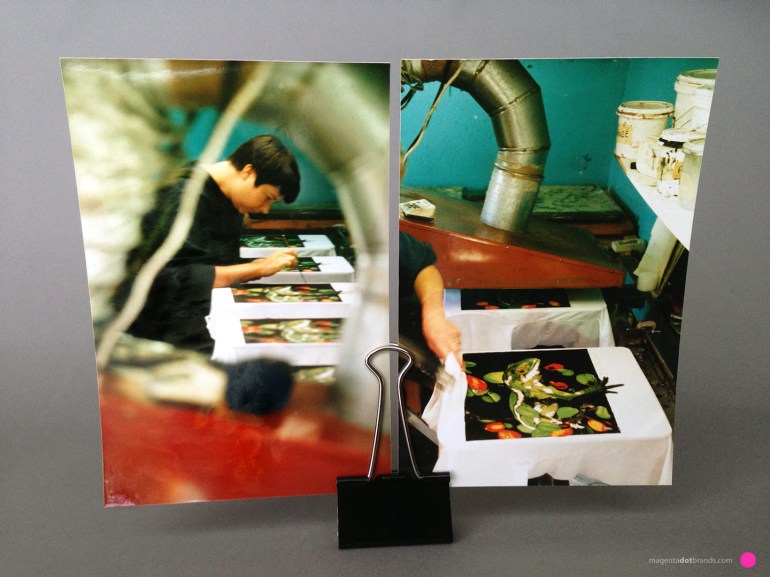 Chrissie proofs each black design while the ink is still wet and manually touches up the black to ensure it is solidly covering where it is supposed to cover.