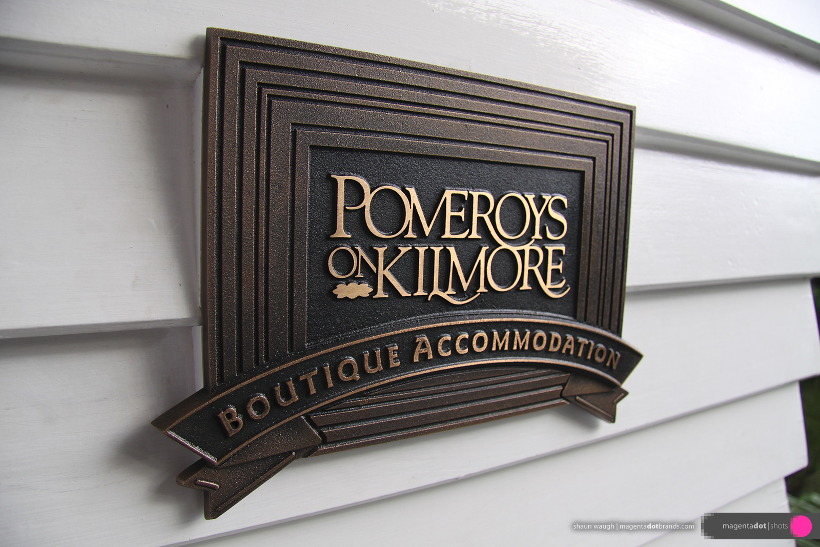 Pomeroy’s Boutique Accommodation cast bronze multi-level name plate located by the front door.
