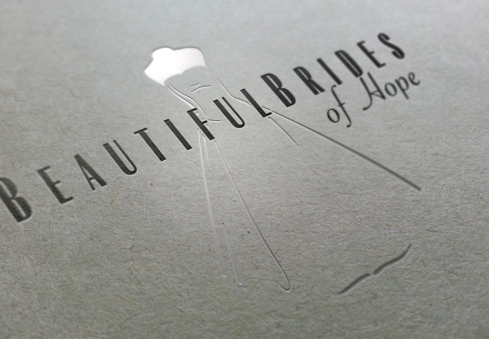 Closeup of Die stamped and silver foiled Beautiful Brides of Hope bridal couture brand. Hope, Nelson, New Zealand. Logo design, Christchurch.