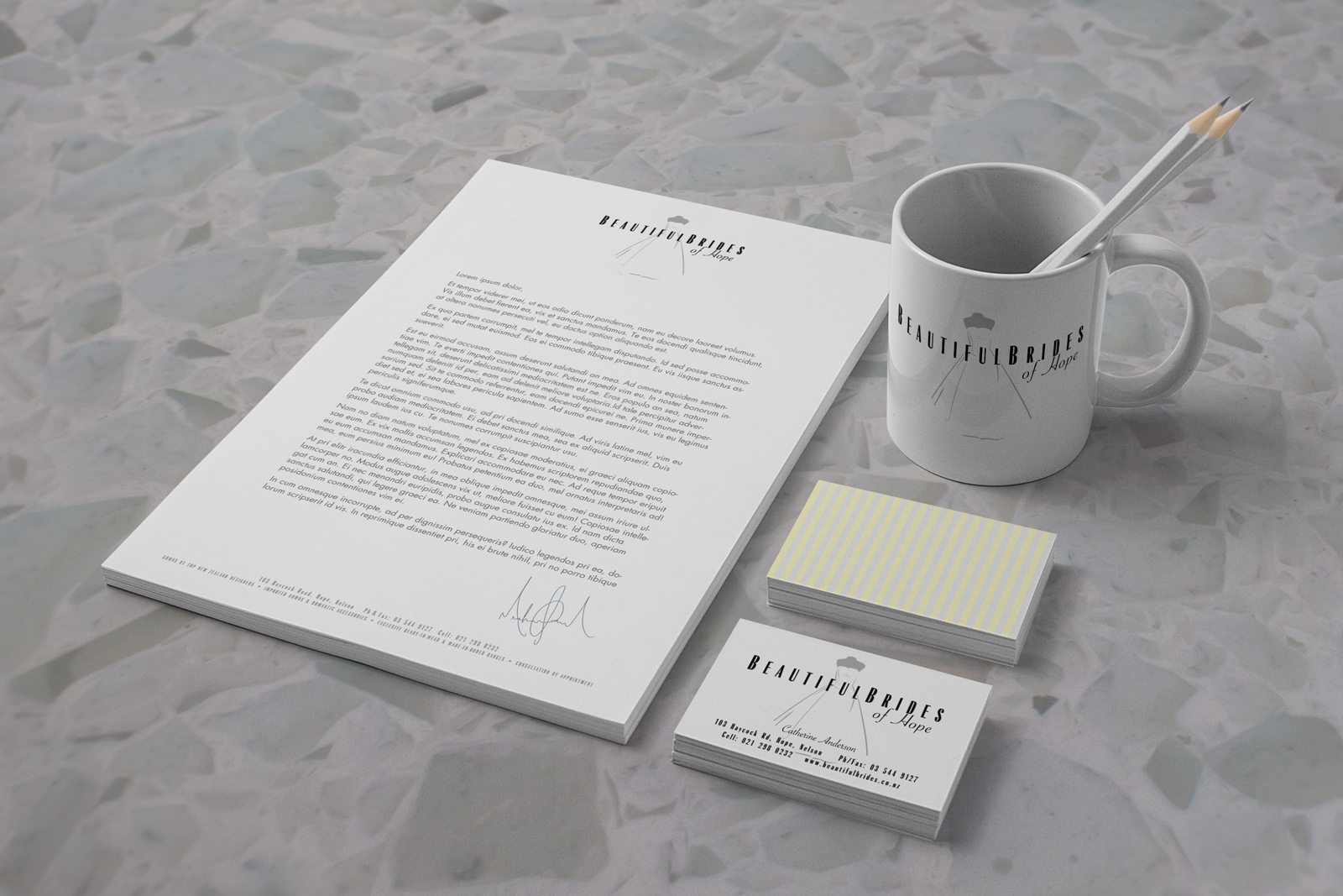 Beautiful Brides of Hope bridal couture stationery system, letterhead, business cards, and promotional coffee mug. Three colours; pastel yellow, pastel grey and black. Logo; symbol within and amongst type, subtle bridal striped patten on the back of letterhead and business card. Brand naming, brand and identity systems design, Illustration, icon design, print production. Originate new company name, Logo design, Christchurch, New Zealand.