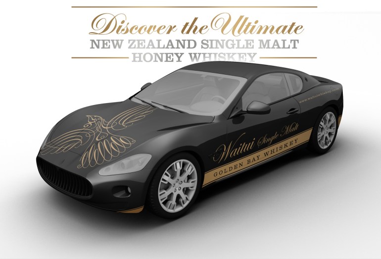 Perspective view of “Waitui Single Malt Golden Bay Whiskey” attractively branded promotional black and gold sports car along with one of Waitui’s distinct message pillars “Discover the Ultimate New Zealand Single Malt Honey Whiskey”. The promotional vehicle is intended to build excitement and anticapation around the launch event and beyond.
