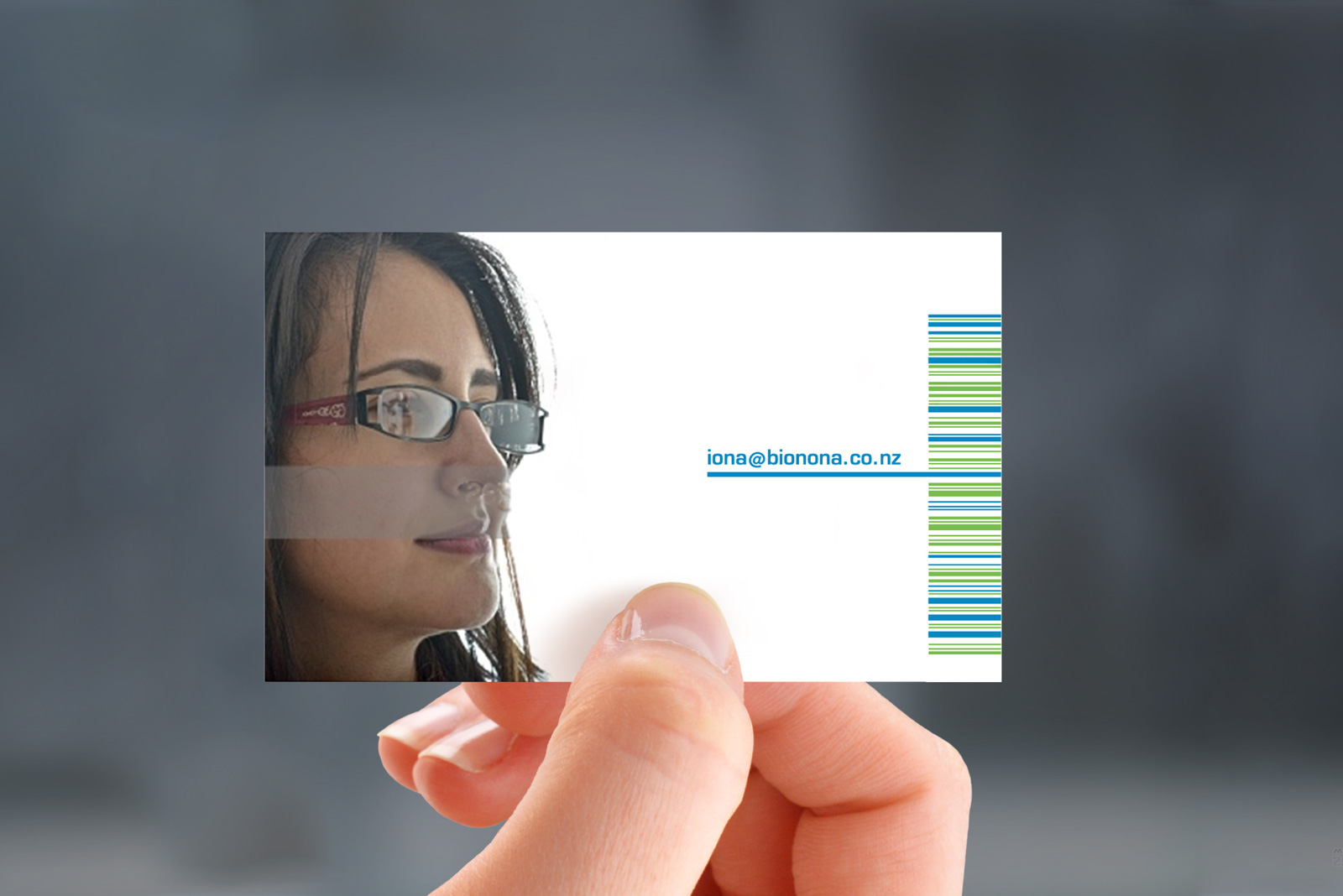 Hand-held photorealistic mockup of back of Bionona business card, printed in 3 colours, litho offset