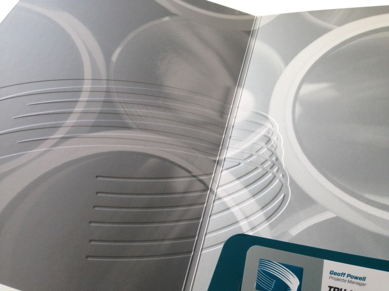 Detail of interior spread of Tru-Line Civil presentation folder with a focus on the up-scale blind emboss spanning front and back cover. Craftsmanship is attention to detail.