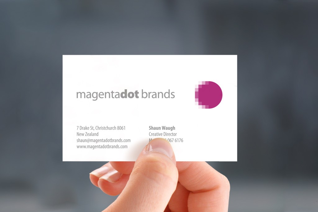 Front of MagentaDot Brands business card, hand held. Front of MagentaDot Brands business card, hand held.
