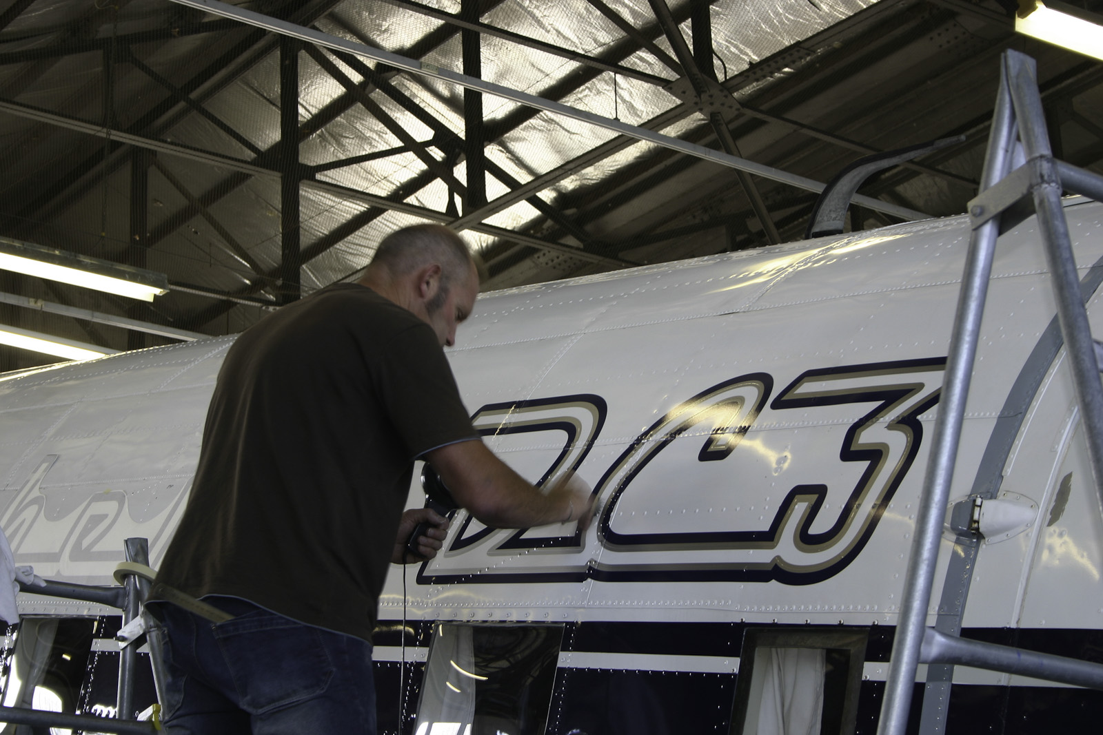 Southern DC3 ZK-AMY livery application, in the Hangar at Wigram