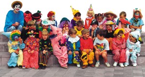 Two dozen Primary school children in clown costumes are happy customers.