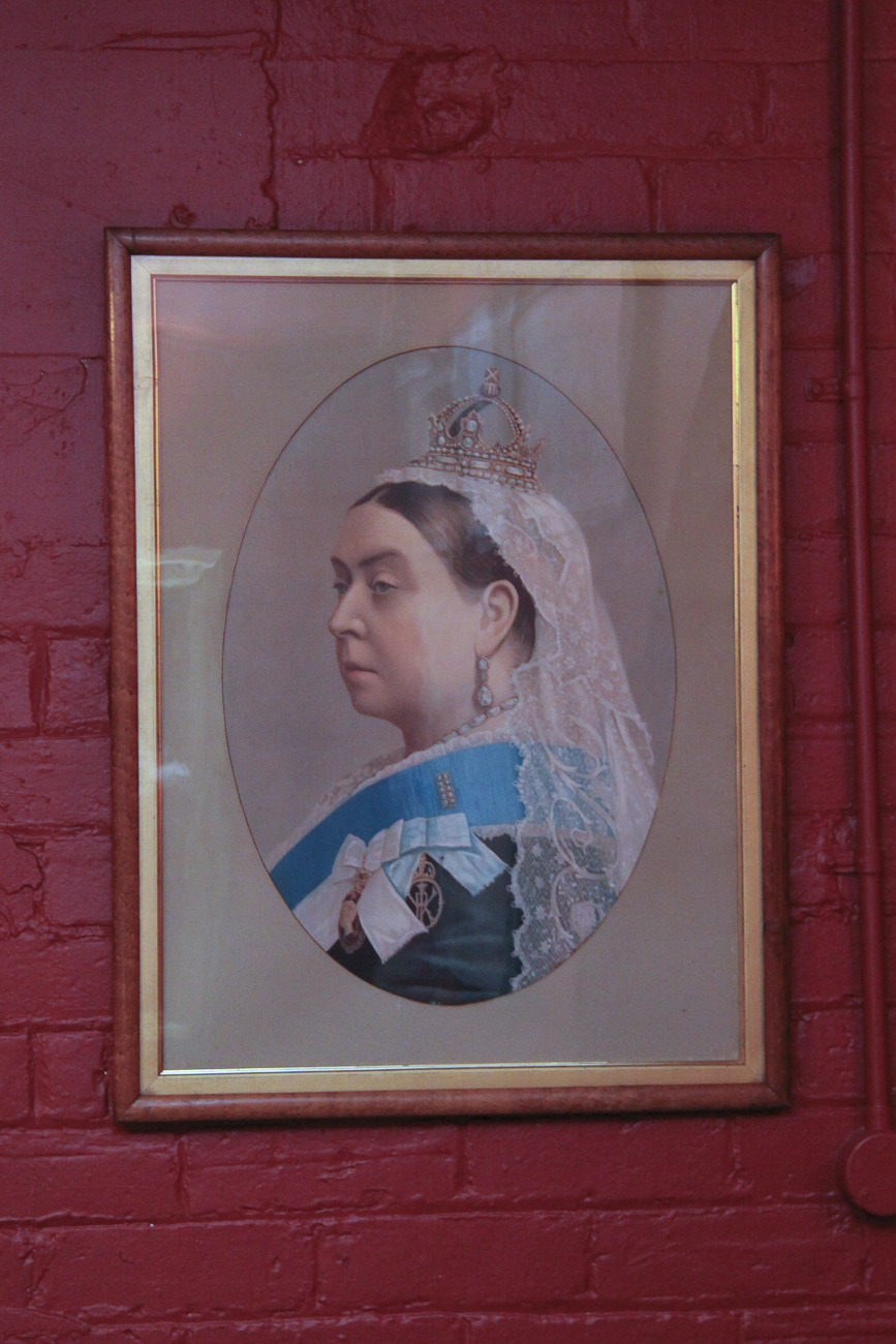 Pomeroy’s Old Brewery Inn English style pub interior details. Portrait of Queen Victoria.