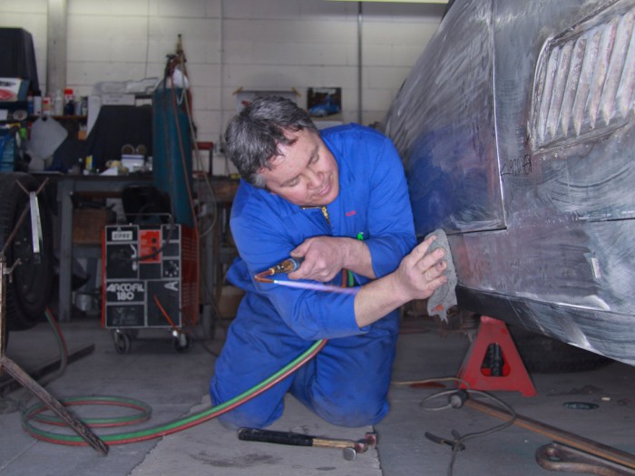 Bob Sterling precision fitting new bespoke aluminium panels on a classic Ferrari restoration in the Panel Shop at Auto Restorations.