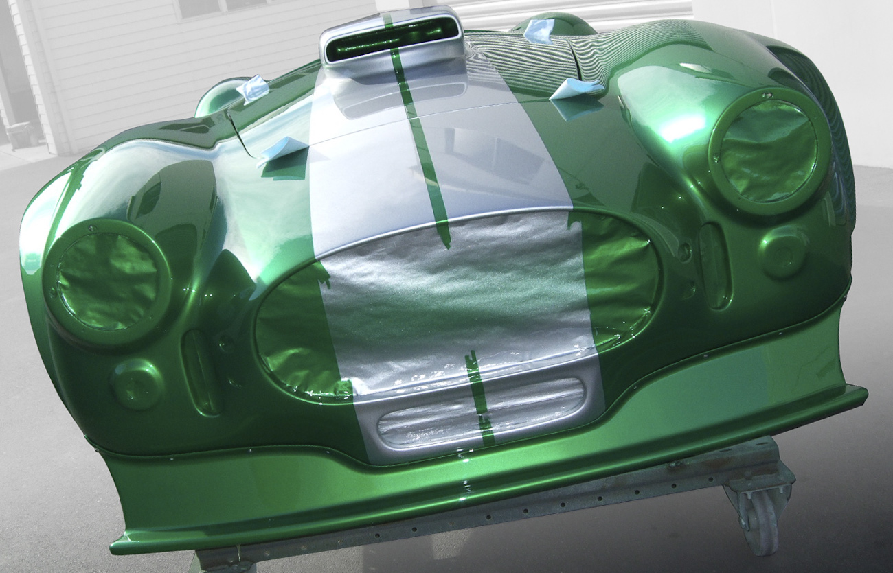 Green Shelby Cobra with two silver stripes, freshly painted in Paint Shop spray booth.