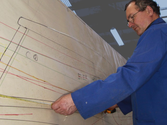 Graeme Climo dimensioning a bespoke aluminium body panel for a classic Delage restoration in the Custom Coachbuilding Shop at Auto Restorations.