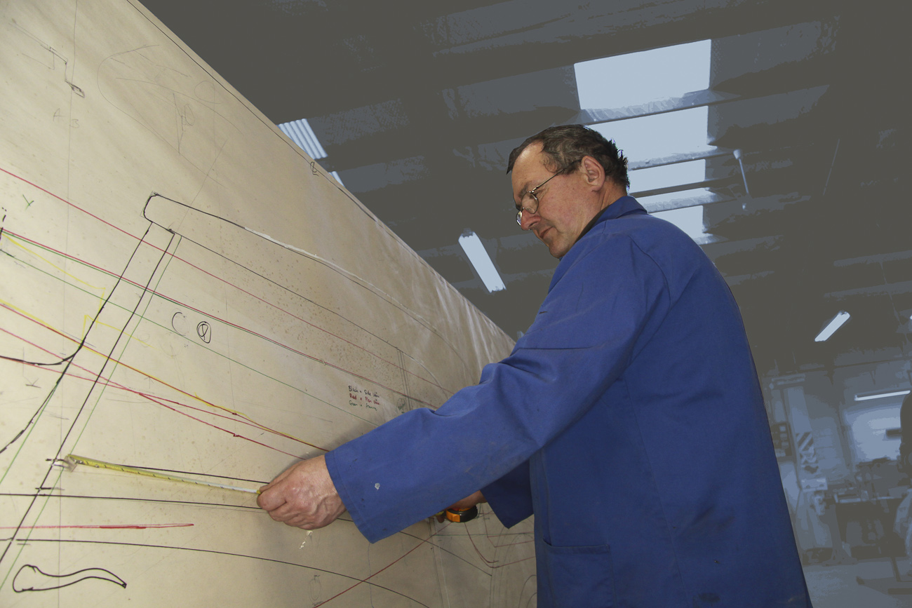 Graeme Climo dimensioning a bespoke aluminium body panel for a classic Delage restoration in the Custom Coachbuilding Shop at Auto Restorations.