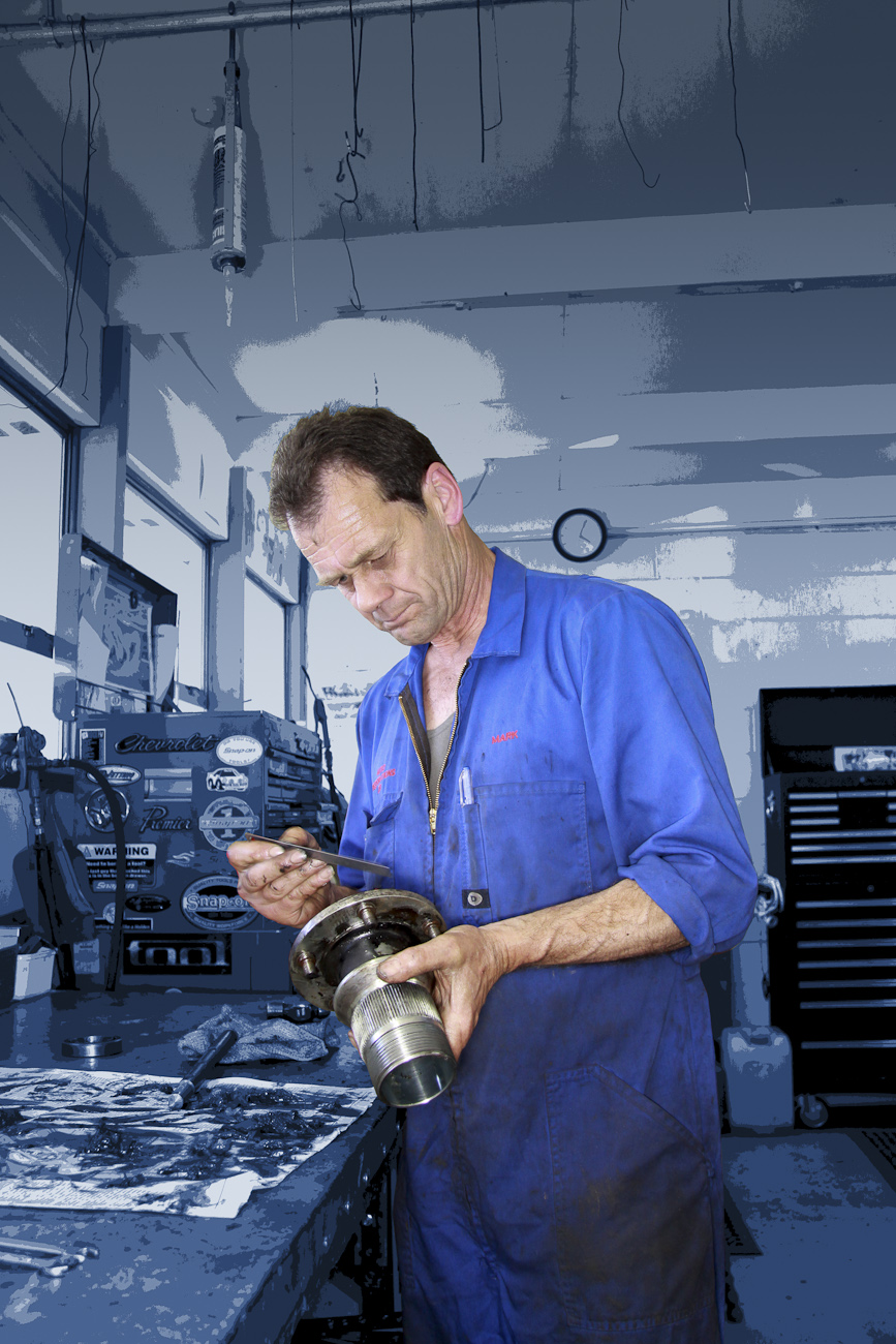Mark Saint Merat hand finishes a bespoke engine part in the Mechanical Workshop at Auto Restorations.