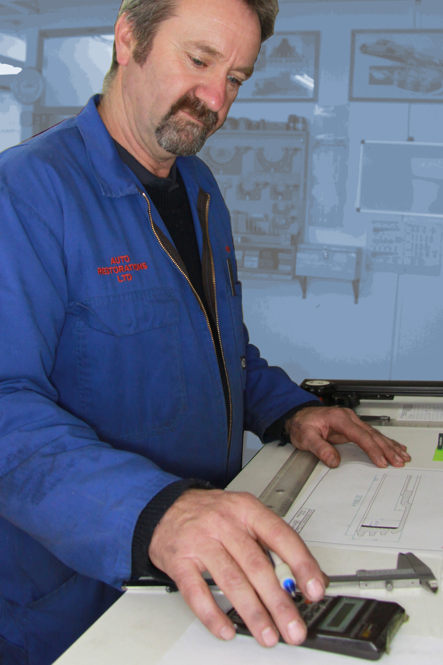 Rob Selby working on a bespoke blueprint of part to be machined for a classic restoration in the Auto Engineering Shop at Auto Restorations.