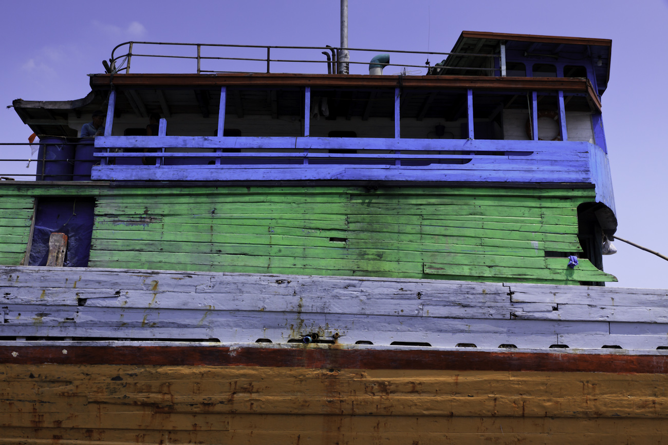 The colourful hull and bridge of a lambo or lamba type of motorised Pinisi at Sunda Kelapa, old harbour of Batavia, now Jakarta.