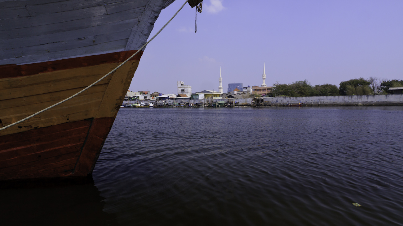 The colourful hull of a lambo or lamba type of motorised Pinisi, named KLM SURYA SANUDRA, moored at the port of Sunda Kelapa, Jakarta, Indonesia.