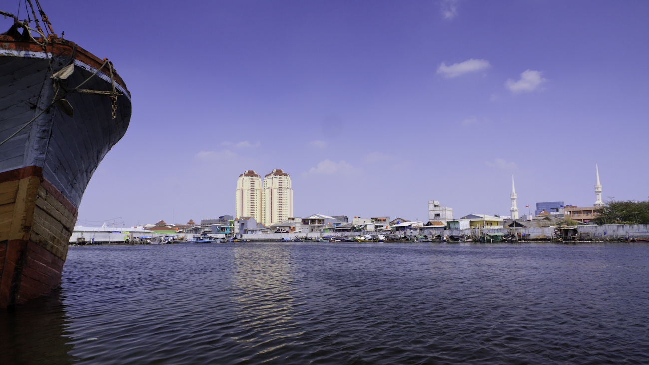 The colourful hull of a lambo or lamba type of motorised Pinisi, named KLM SURYA SANUDRA, moored at the port of Sunda Kelapa, Jakarta, Indonesia.