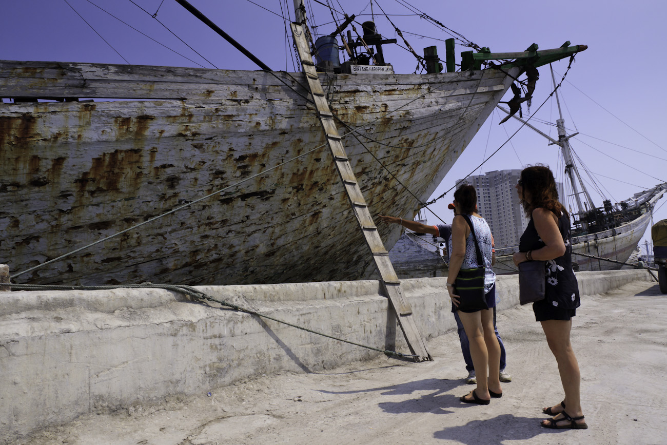 My sister and my wife with our guide on a tour of the Port of Sunda Kelapa, Jakarta, Indonesia. This boat Bintang Harapan Jaya is In need of a paint job and it is sporting a typical wooden cargo boat gangplank.