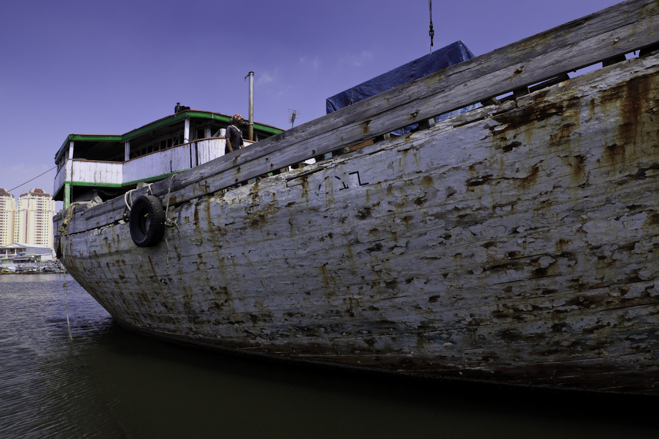 On a tour of the Port of Sunda Kelapa, Jakarta, Indonesia. This boat Bintang Harapan Jaya is In need of a paint job and it is sporting a typical wooden cargo boat gangplank.