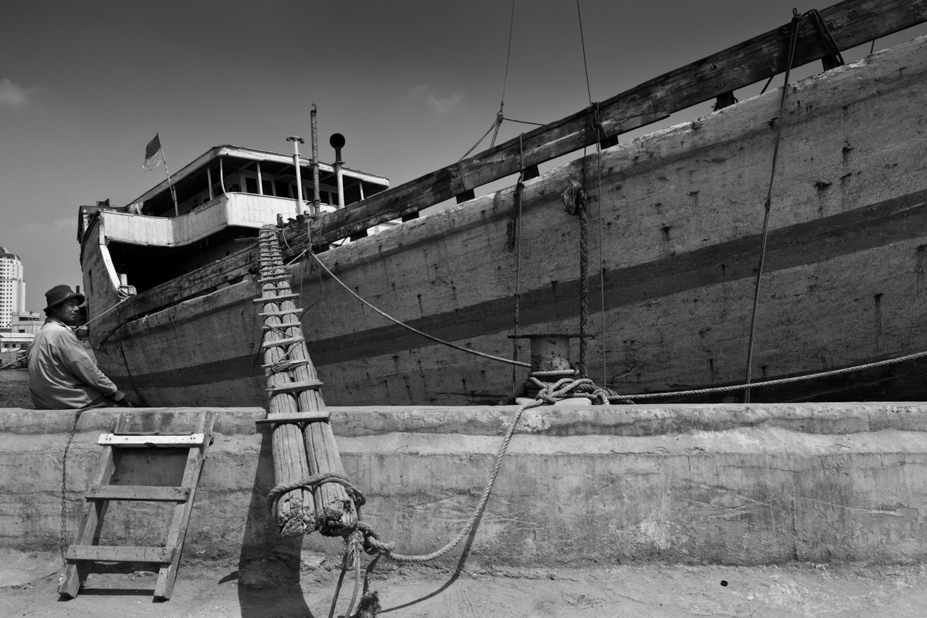 A typical wooden cargo boat gangplank. These magnificent Makassar schooners called Pinisi are an important means of transporting goods to and from the outer islands of Indonesia.