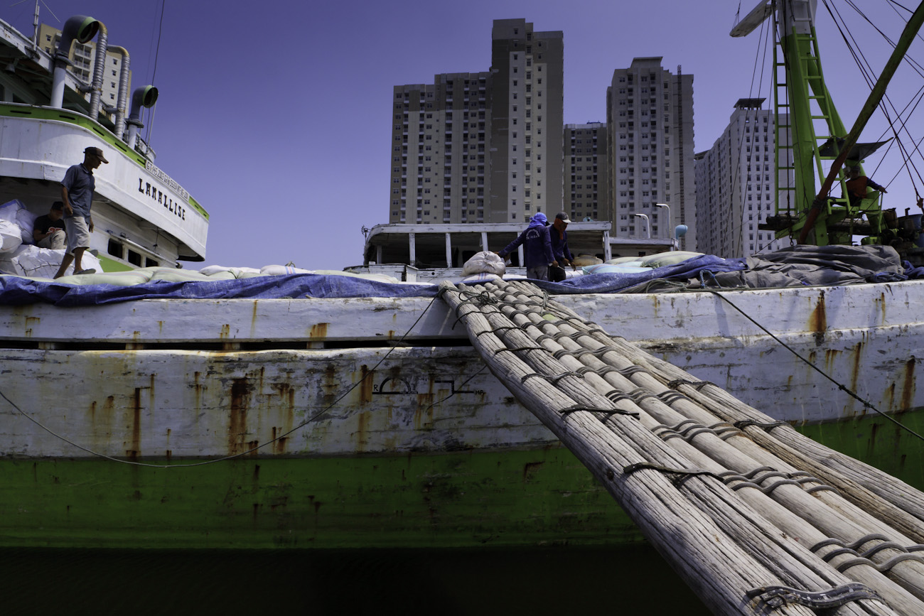 Traditional wooden gangway connects the deck of a magnificent Makassar motorised Pinisi named ‘Lamallise’ to the wharf at the port of Sunda Kelapa, Jakarta, Indonesia.