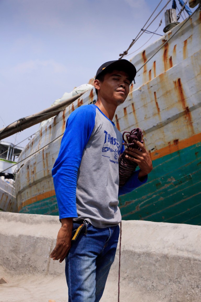 Coolie poses for a portrait on the wharf at the old port of Sunda Kelapa, Jakarta, Indonesia.