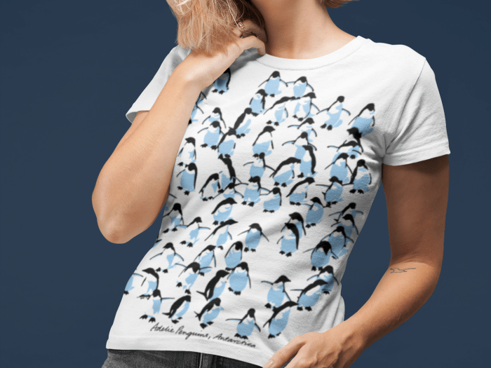 a woman in an Adelie penguin white t-shirt with her all over her face