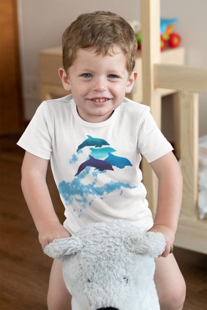 A dolphins leaping New Zealand onesie on a baby boy playing in his room.