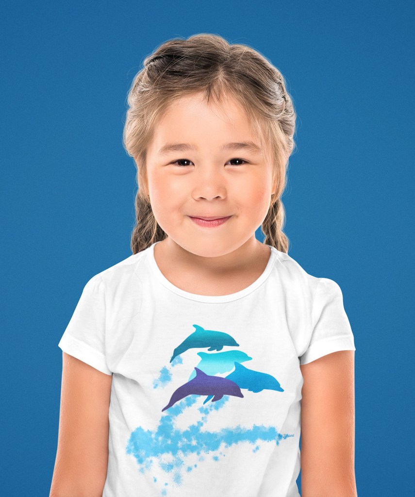 A little girl wearing a dolphins leaping New Zealand t-shirt at a studio.