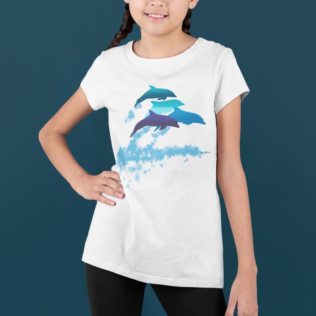 A smiling girl with two braids in a dolphins leaping New Zealand t-shirt.