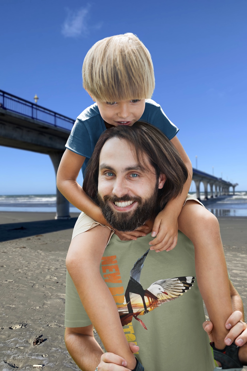 A father playing with his son on New Brighton beach wearing a Surface Active Red-billed gull, New Brighton, New Zealand t-shirt.