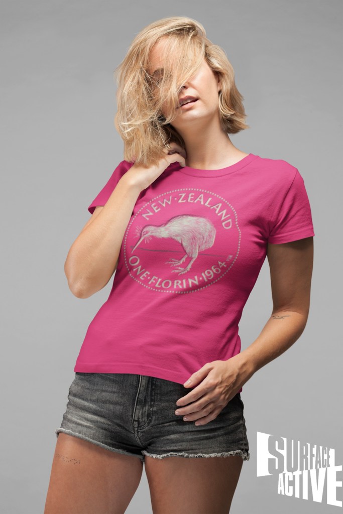 A Surface Active Kiwi one florin New Zealand t-shirt worn by a woman in a studio with her hair all over her face.
