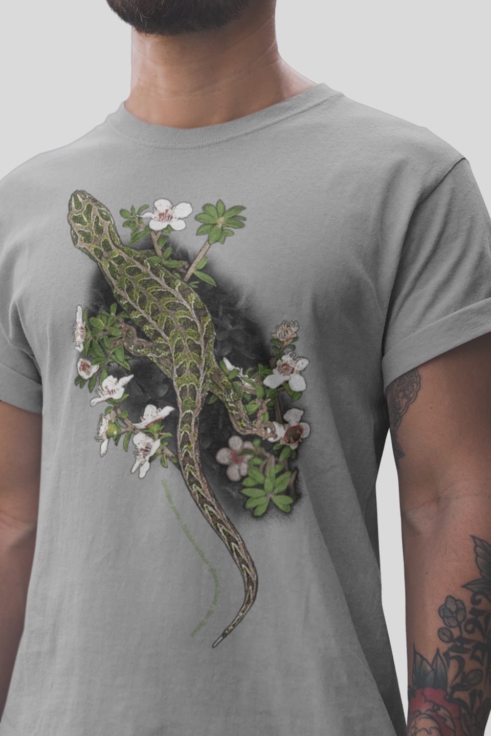 Close-up of a man wearing a t-shirt with the Surface Active Harlequin Gecko print, showing detailed, geometric patterns.