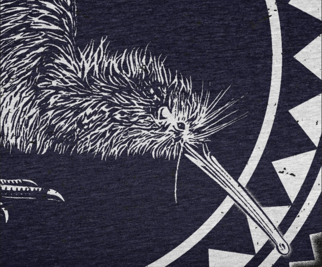 Detailed close-up view of our Surface Active Iconic Kiwi, New Zealand design all-over printed on a black t-shirt.