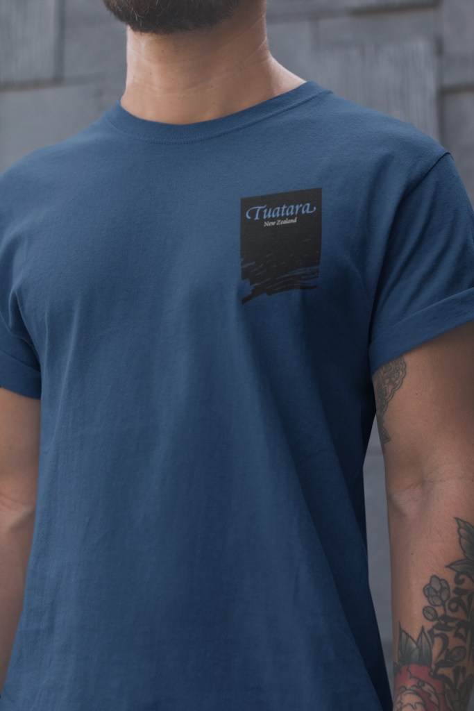 Close-up of the three colour chest badge print on the front of the two-sided Tuatara, New Zealand multicolour design.  