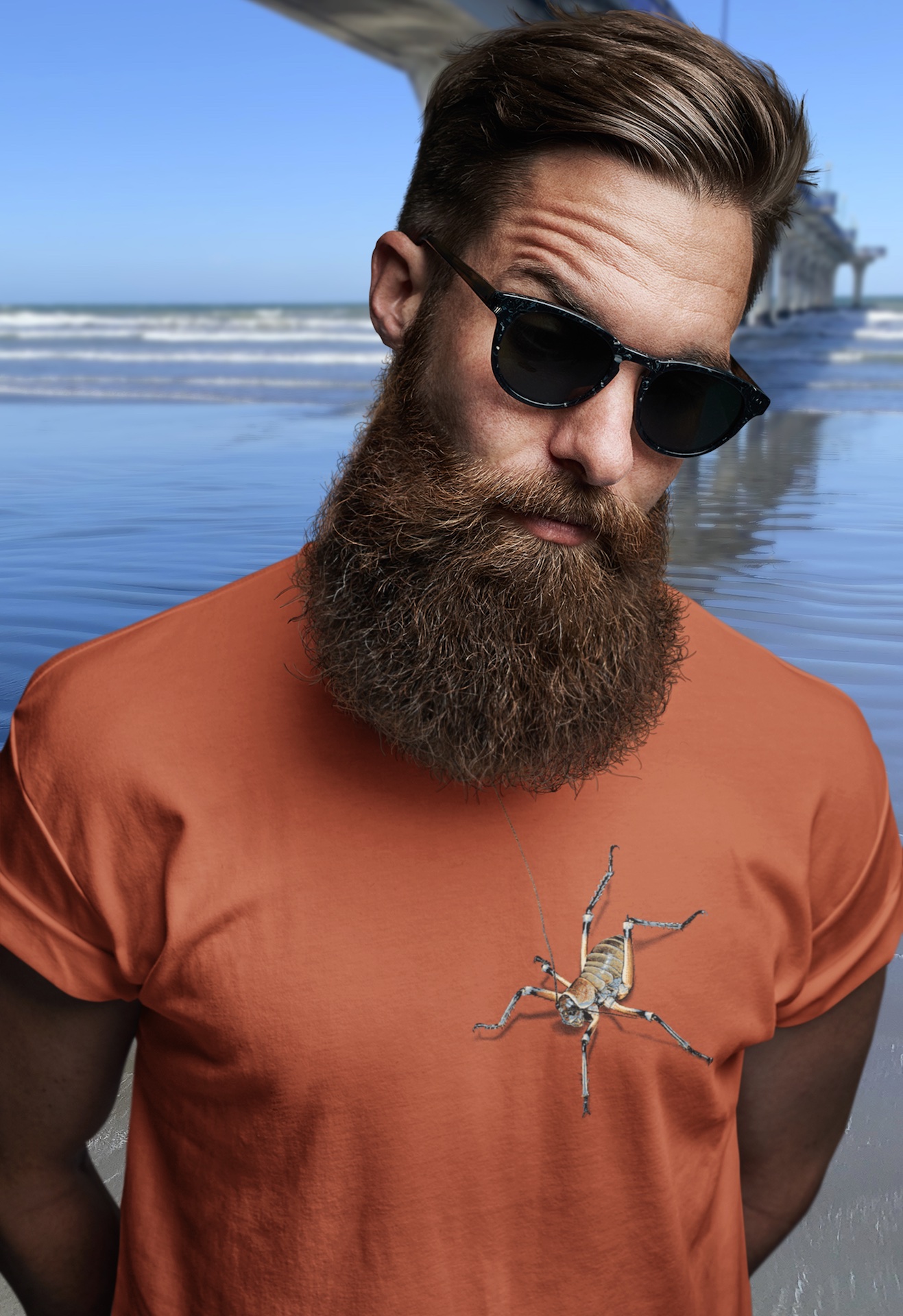 A rust orange Surface Active t-shirt with two colourful pixel painted weta on the front of the shirt, one on the sleeve and one on the back.