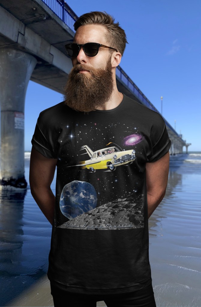 A black Surface Active t-shirt with illustration of a 1961 Ford MkII Zephyr re-imagined as NASA’s space shuttle being modelled by a customer beside New Brighton Pier.