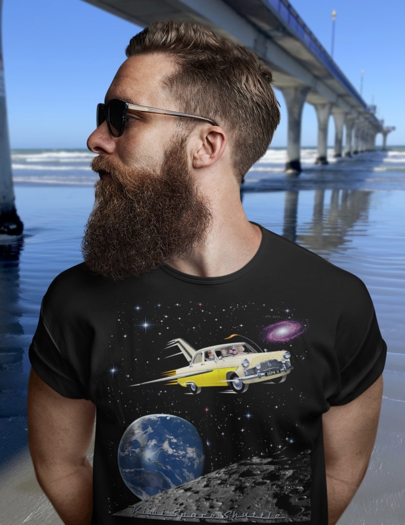 A black Surface Active t-shirt with illustration of a 1961 Ford MkII Zephyr re-imagined as NASA’s space shuttle being modelled by a customer beside New Brighton Pier.