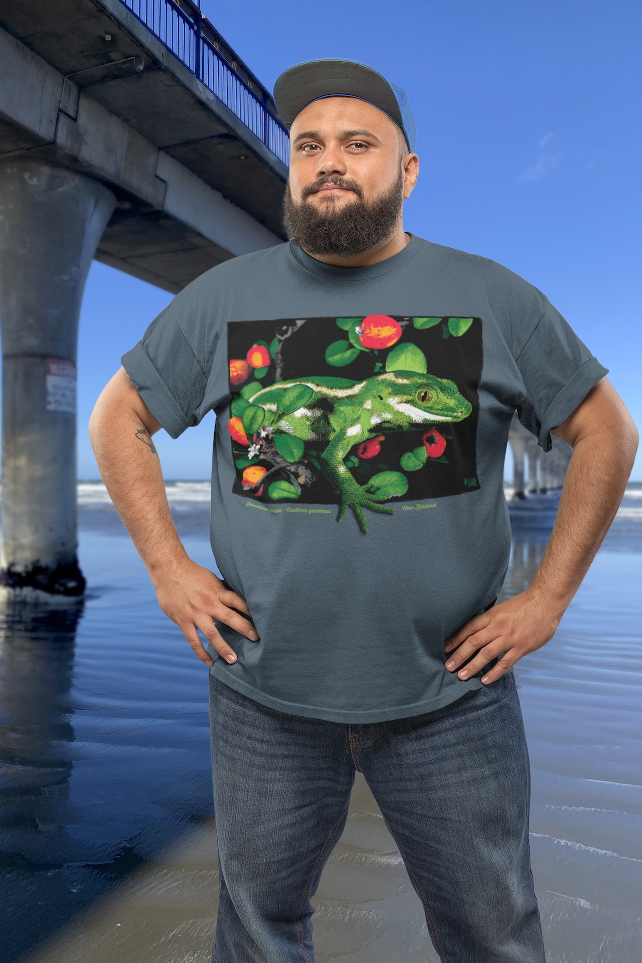 Man wearing a jewelled gecko t-shirt standing beside New Brighton Pier.