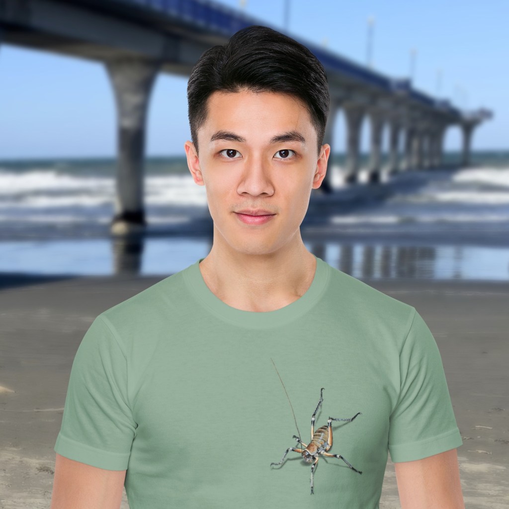 A sage green Surface Active t-shirt with two colourful pixel painted weta on the front, one on the sleeve and one on the back.