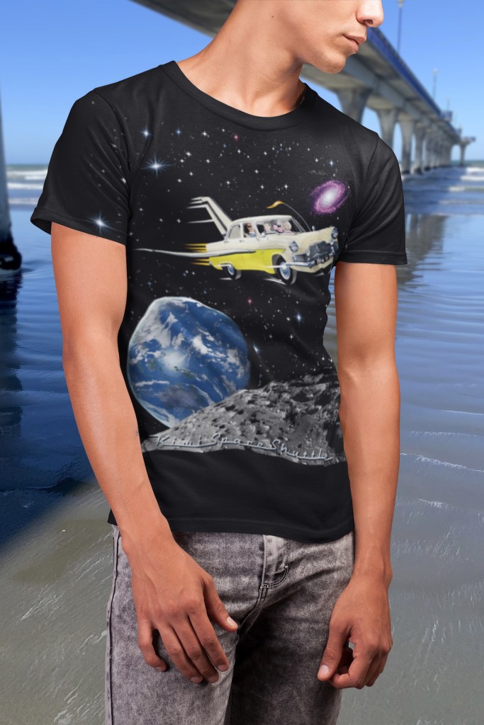 A black Surface Active t-shirt with illustration of a 1961 Ford MkII Zephyr re-imagined as NASA’s space shuttle being modelled by a customer beside New Brighton Pier.