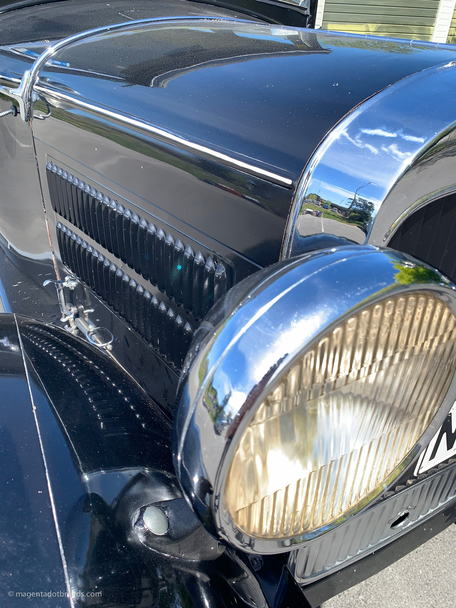 Abstract close-up view of the right hand side headlight and louvered bonnet of a restored 1928 Essex Super Six