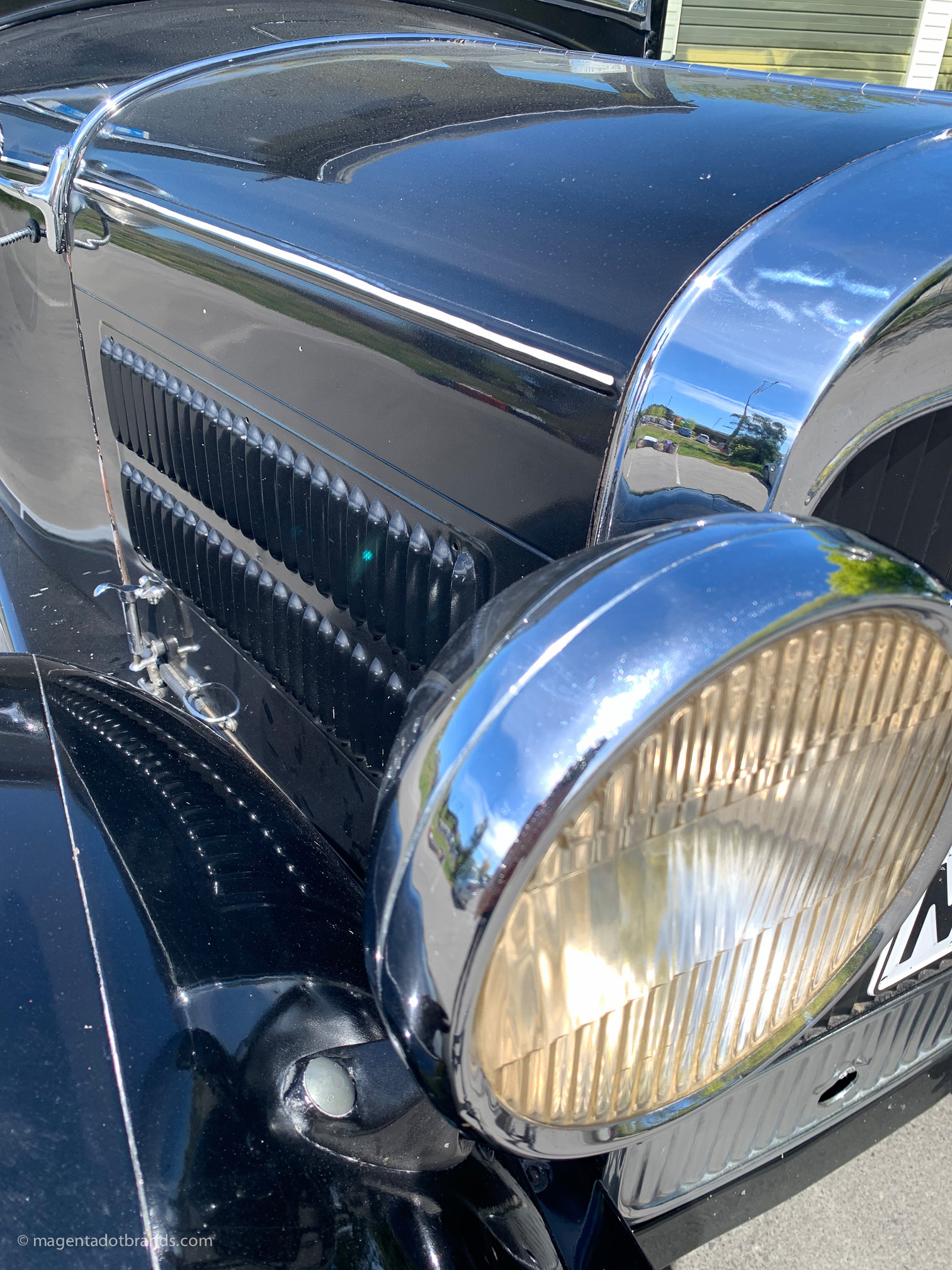 Abstract close-up view of the right hand side headlight and louvered bonnet of a restored 1928 Essex Super Six