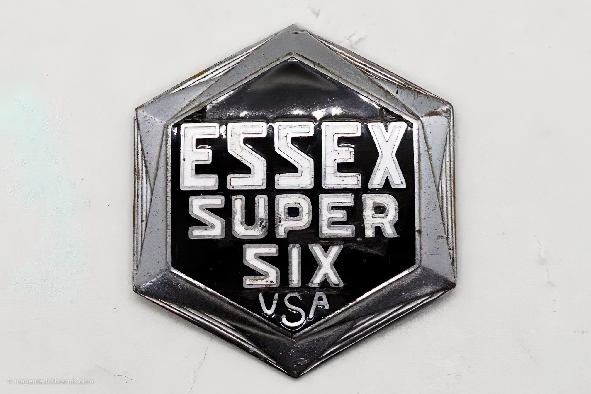 An Essex Super Six USA bonnet emblem badge