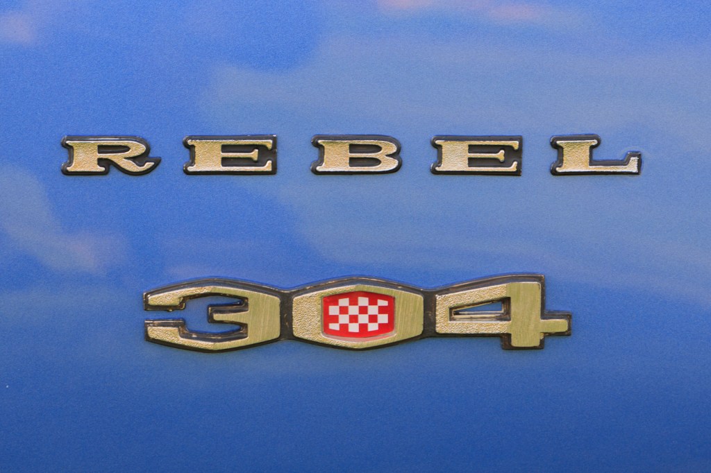Close-up of 'Rebel - 304' badge on the royal blue fender of a restored 1970 Rambler Rebel SST.