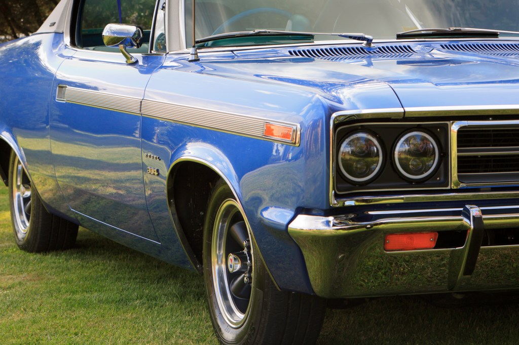 Close-up front view of a restored 1970 Rambler Rebel SST in royal blue, featuring modern LED headlights for improved lighting efficiency.