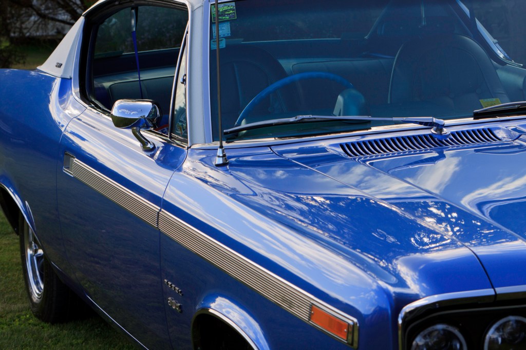 Close-up of the royal blue 1970 Rambler Rebel SST's hood leading to the windscreen, showcasing the car's restored beauty and detailing.