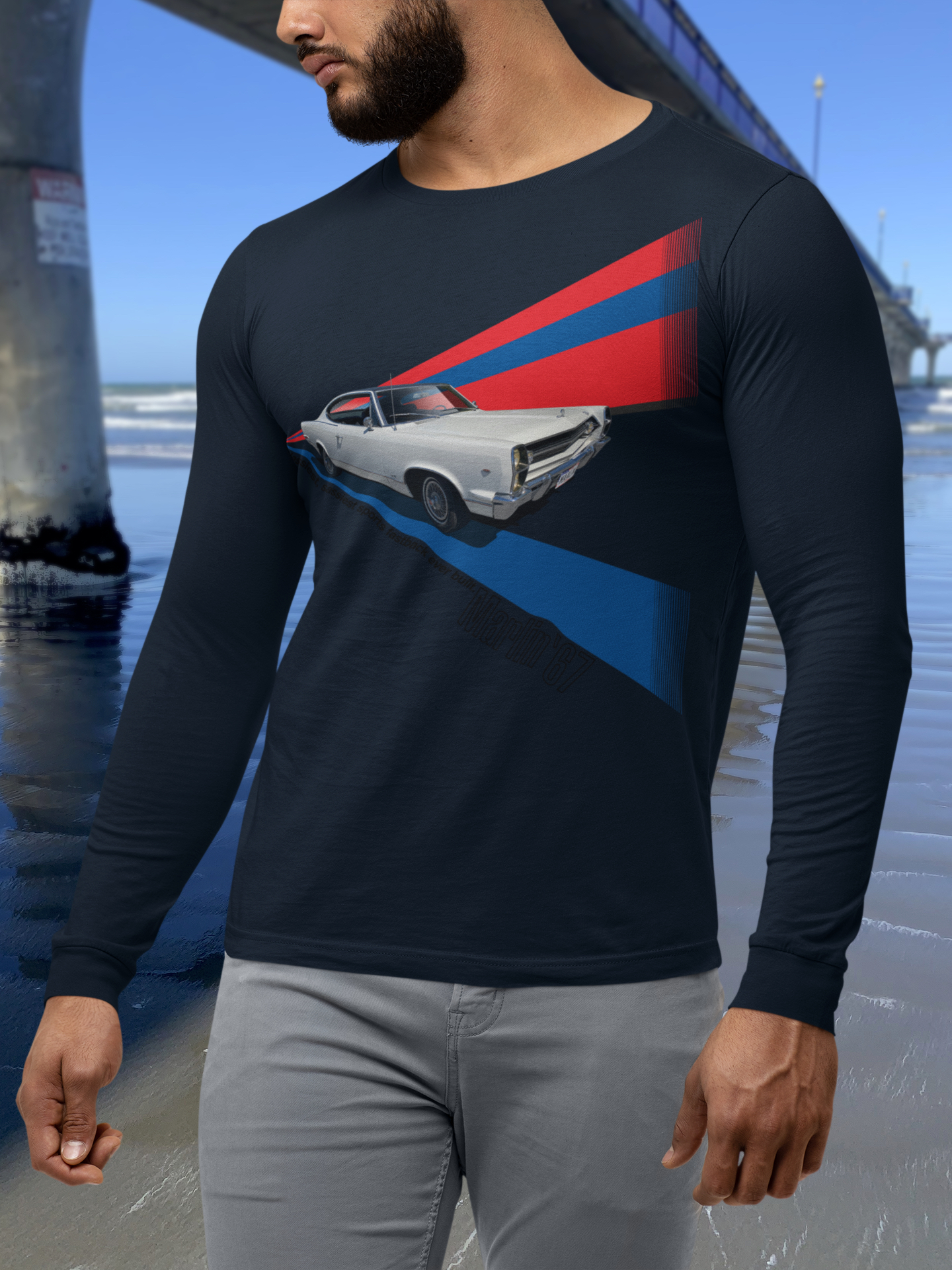 Man in navy blue AMC Marlin long-sleeve t-shirt beside New Brighton Pier.