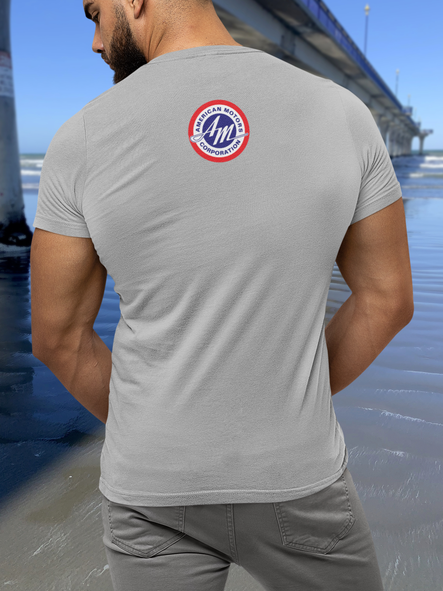 Back view of man in grey marle t-shirt with 1967 AMC Marlin design, featuring a round AMC badge print.