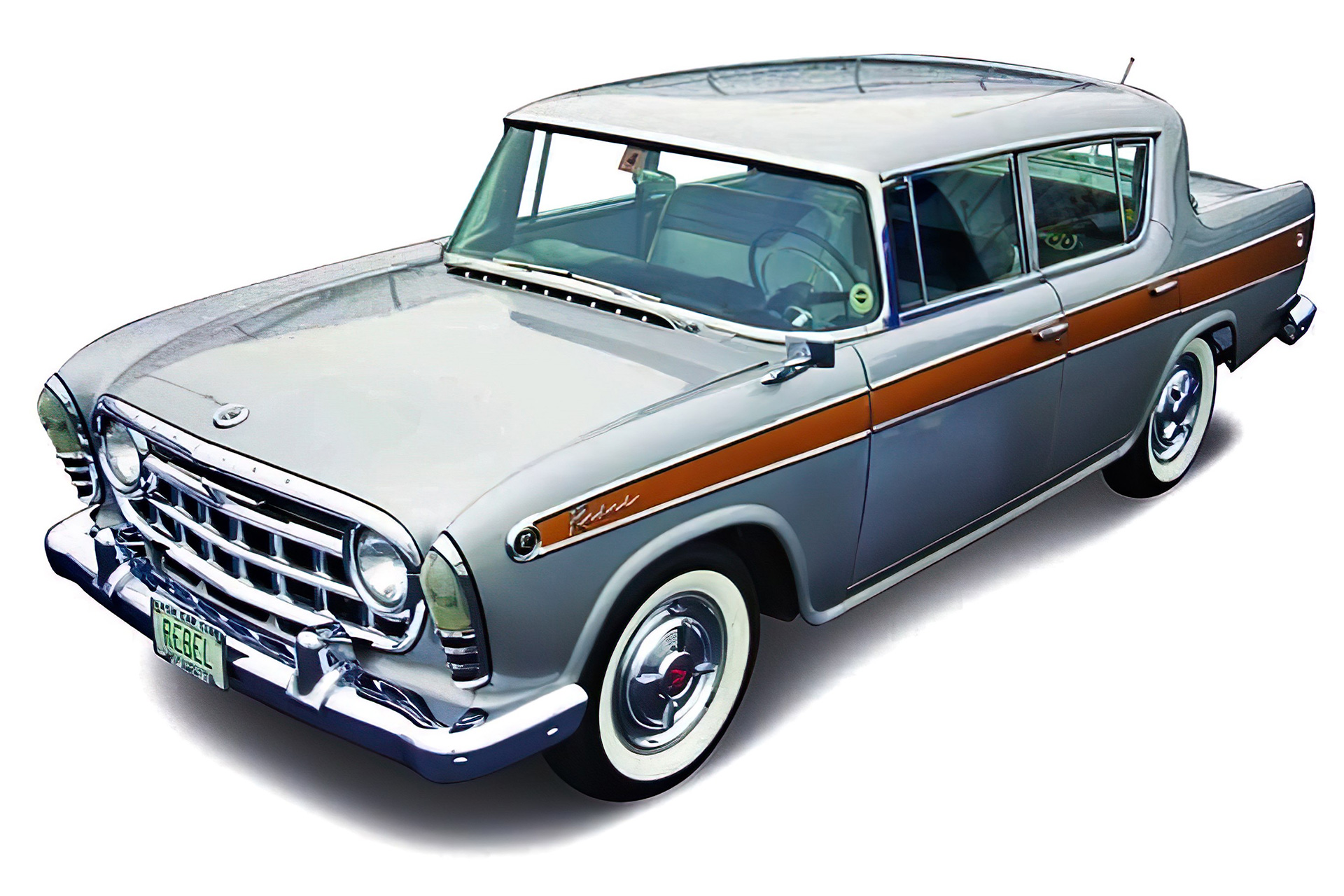 Photocomposite of a 1957 Rambler Rebel sedan clear-cut on a white background, showcasing its metallic silver finish and unique design.
