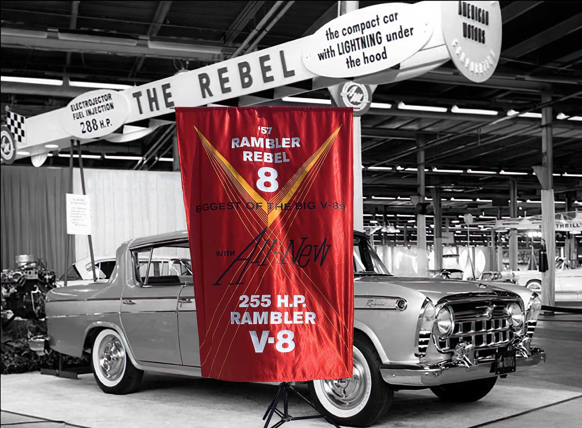Photocomposite of a 1957 Nash Rambler silk banner in lustrous red with a black-and-white 1957 Rambler Rebel sedan auto show image.